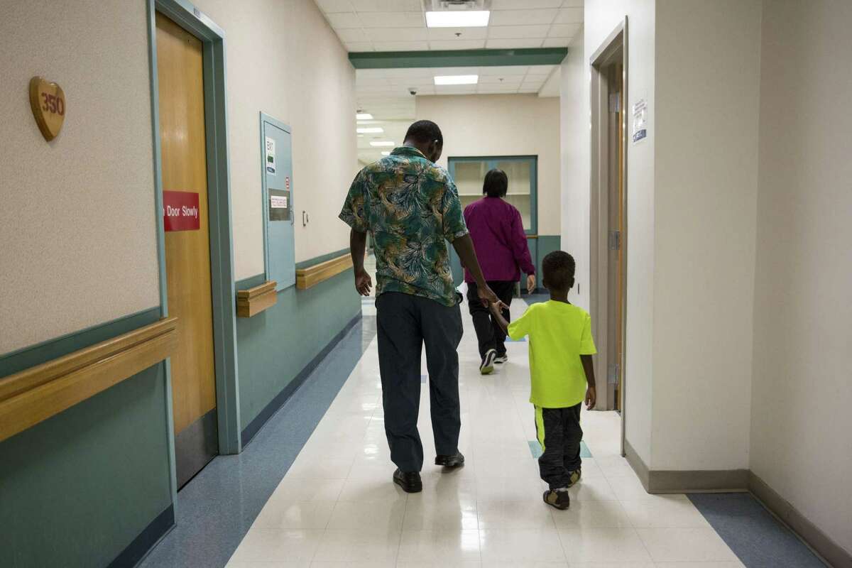 Bashir Maalim (left) holds Hamza Mohamud's hand during a follow-up appointment at University Hospital in San Antonio on Oct. 27. Hamza was born with a congenital heart defect; however, his family could not access the medical care and surgery he required in their home country of Kenya. Hamza was referred to HeartGift by a physician in Kenya. Dr. Adil Husain performed the procedure in San Antonio.