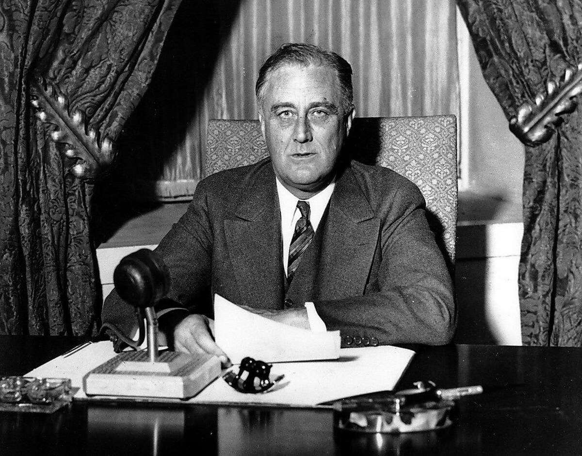 FILE -- President Franklin D. Roosevelt prepares to begin his first fireside chat to the American people in this March 12, 1933 file photo. Speaking to the nation on radio from the White House in Washington, Roosevelt explained in simple langauge the measures he was taking to solidify the nation's shaky banking system. Roosevelt had been in office less than 100 days. (AP Photo/File)