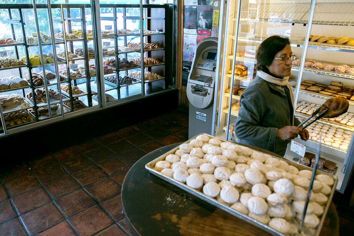 Luz Rioja, who is visiting from Peru, grabs a bread, at La Victoria, a bakery, on Tuesday, Nov. 22, 2016 in San Francisco, Calif. Rioja said she always buys bread here when she visits from Peru.
