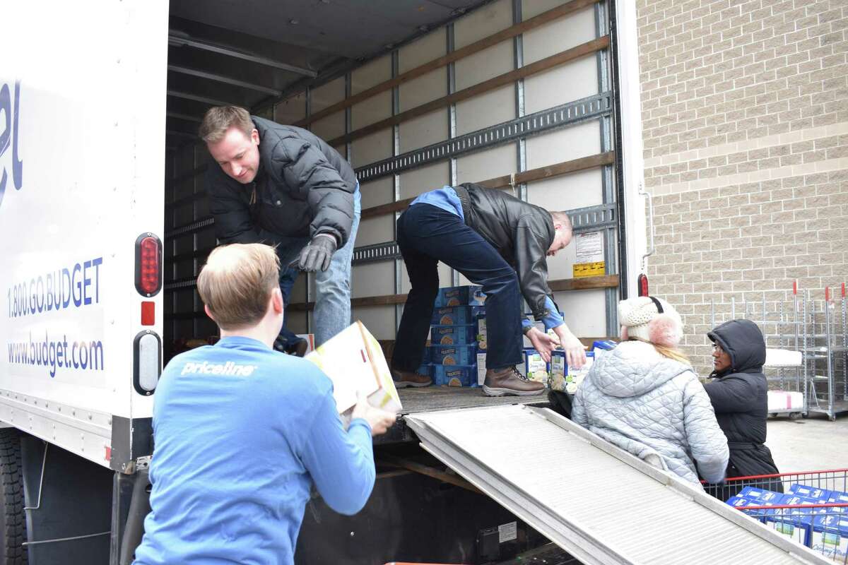 Volunteers with Priceline.com load a truck with donated supplies on Monday, Nov. 21, 2016 at Costco on Connecticut Ave. in Norwalk, Conn., destined for the Food Bank of Lower Fairfield County for distribution to nonprofits throughout the region.