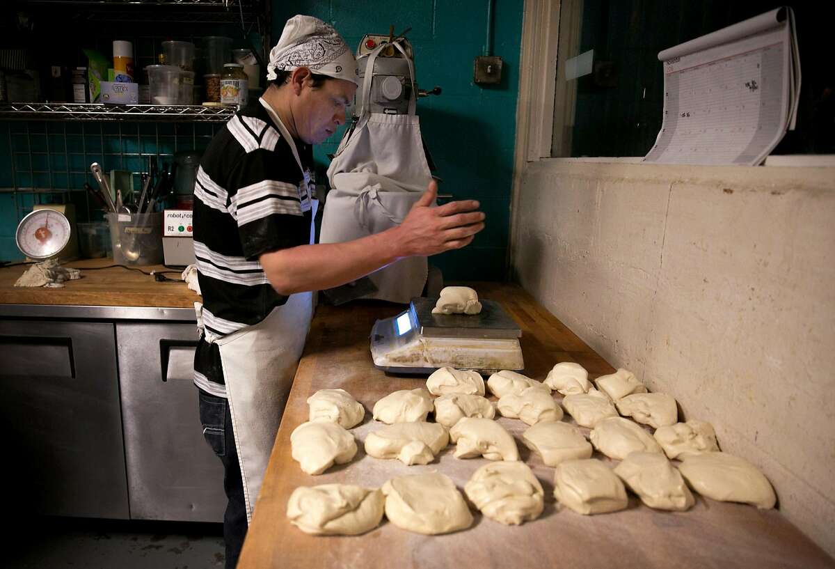Cesar Rolando Canales, a baker, prepares the bread at La Victoria, on Tuesday, Nov. 22, 2016 in San Francisco, Calif.