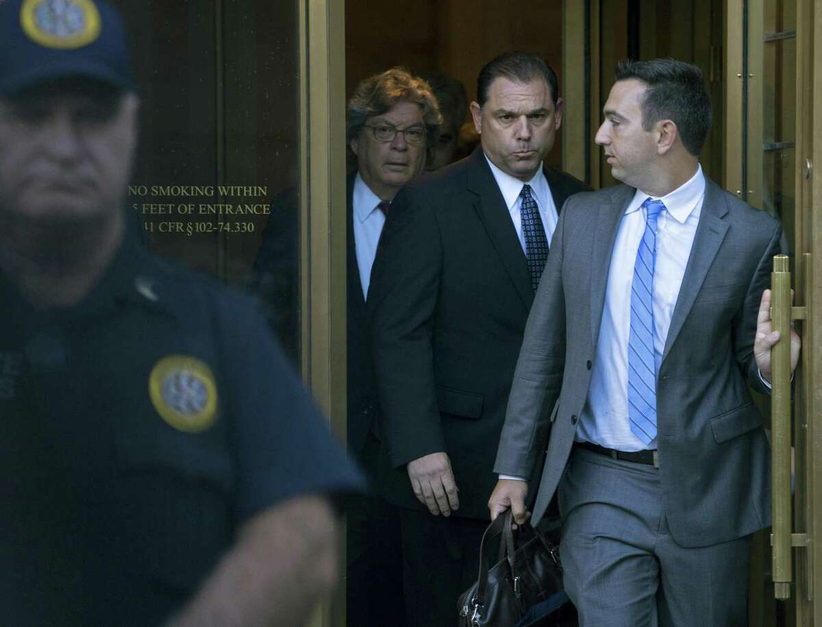 Joseph Percoco, center right, a former executive deputy secretary to Gov. Andrew Cuomo, leaves federal court in New York Thursday, Sept. 22, 2016. Federal authorities accused Percoco of soliciting more than $300,000 in bribes from an energy company and a Syracuse developer.