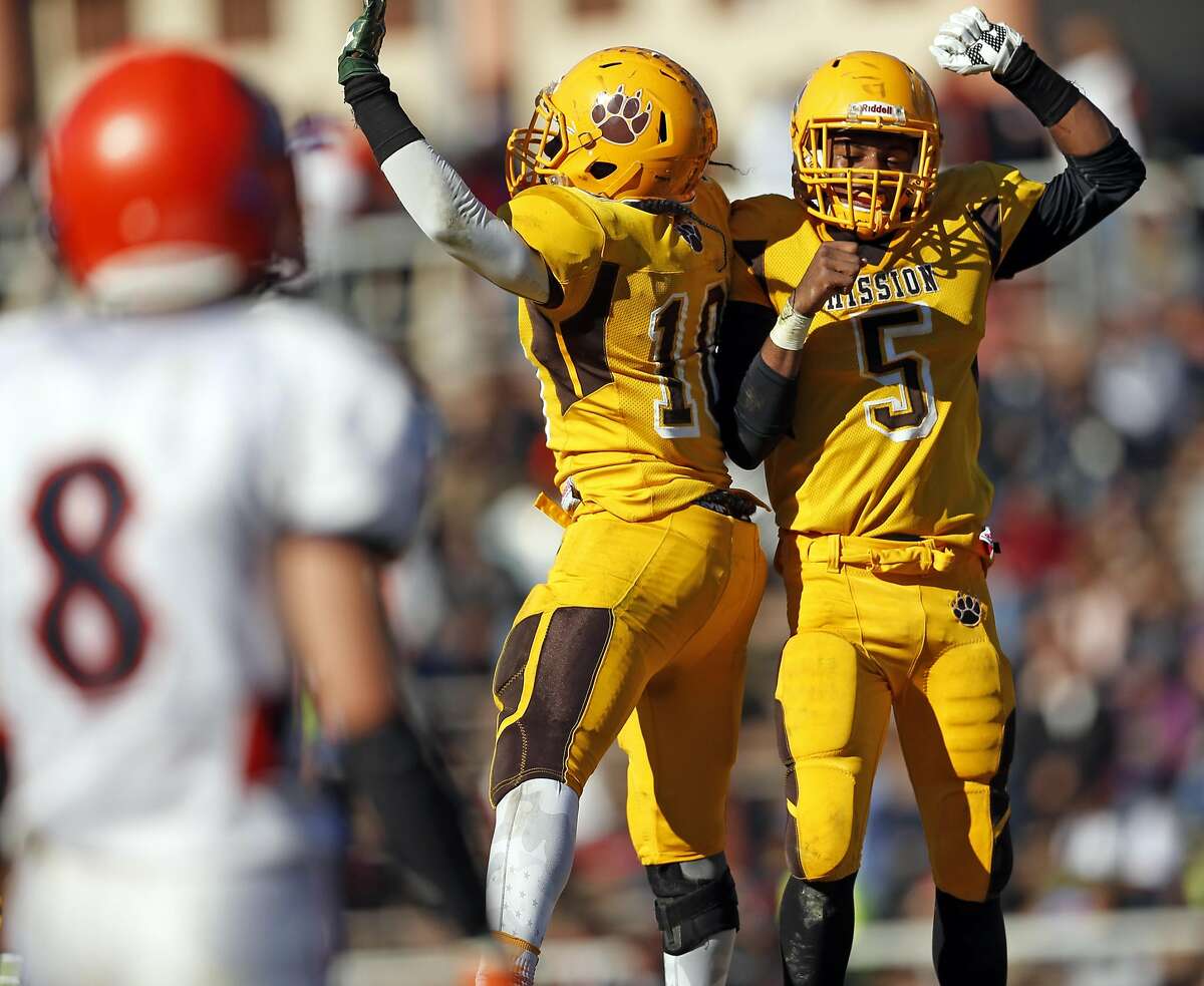 Mission's Niamey Harris (5) and Anthony Porter celebrate Harris' 4th quarter touchdown run during 14-13 win over Balboa during SF Section Championship Game at Kezar Stadium in San Francisco., Calif., on Thursday, November 26, 2015.