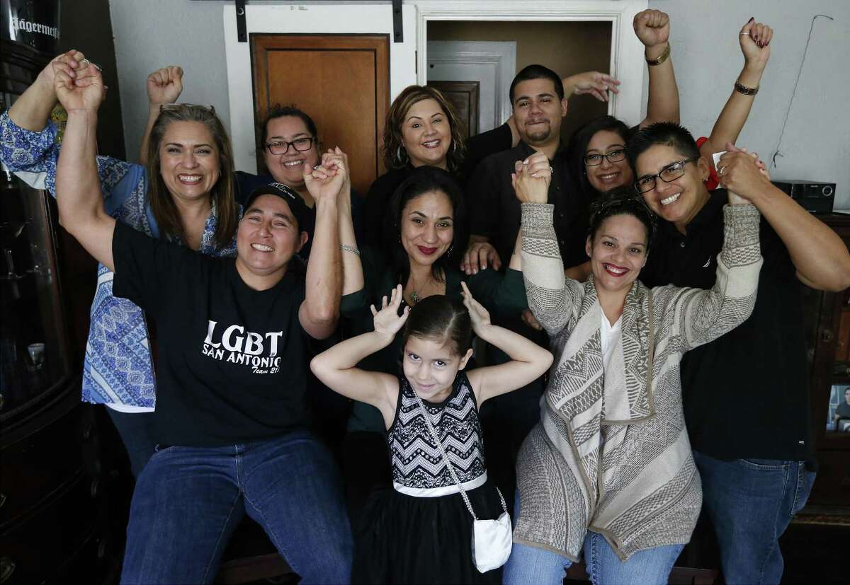 Three of the "San Antonio Four" along with family and friends gather to react to the news of being exonerated by the Texas Court of Criminal Appeals for being convicted of sexual assault of two young girls in 1990s. Anna Vazquez (from left, front), Cassandra Rivera and Elizabeth Ramirez met with media on Wednesday, Nov. 23, 2016 as news emerged of their exoneration. Kristie Mayhugh was not present at the gathering due to work. (Kin Man Hui/San Antonio Express-News)