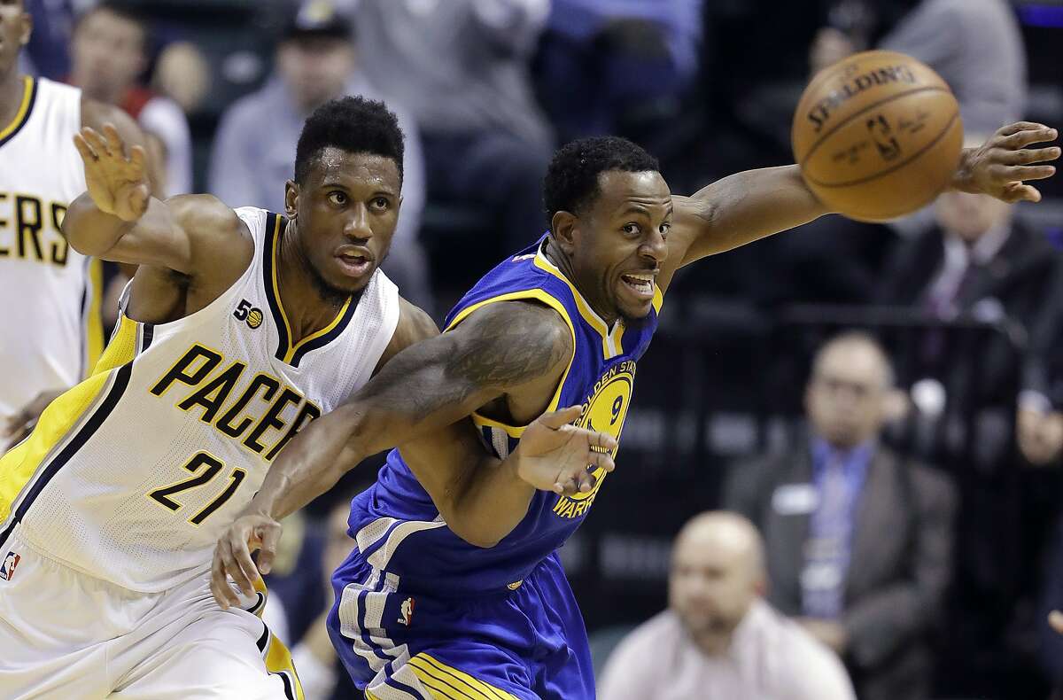 Indiana Pacers' Thaddeus Young (21) and Golden State Warriors' Andre Iguodala go for the ball during the first half of an NBA basketball game Monday, Nov. 21, 2016, in Indianapolis. (AP Photo/Darron Cummings)