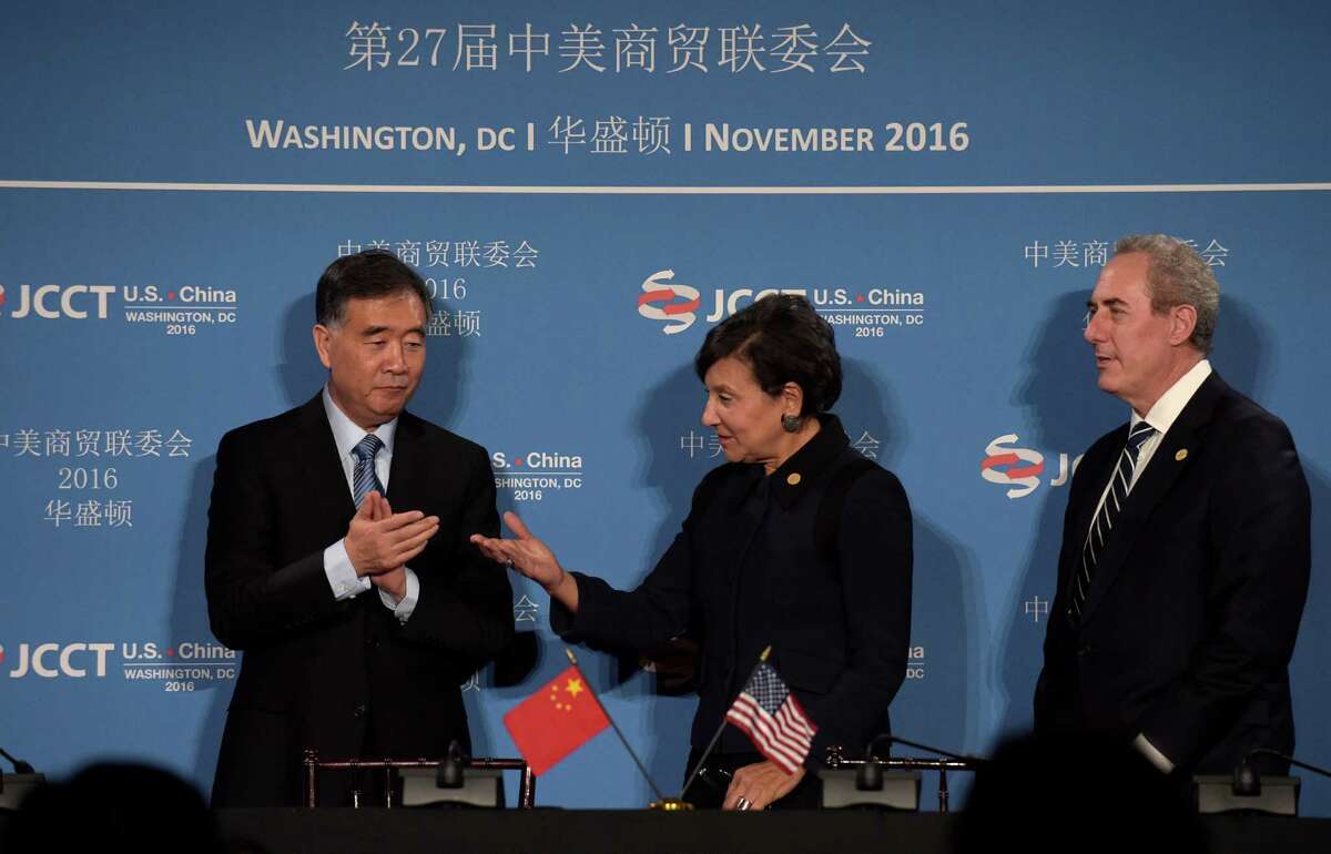 Commerce Secretary Penny Pritzker, center, talks with Chinese Vice Premier of the State Council Wang Yang, left, with U.S. Trade Representative Ambassador Michael Froman at right, following a signing ceremony at the 27th session of the U.S.-China Joint Commission on Commerce and Trade in Washington, Wednesday, Nov. 23, 2016. (AP Photo/Susan Walsh)