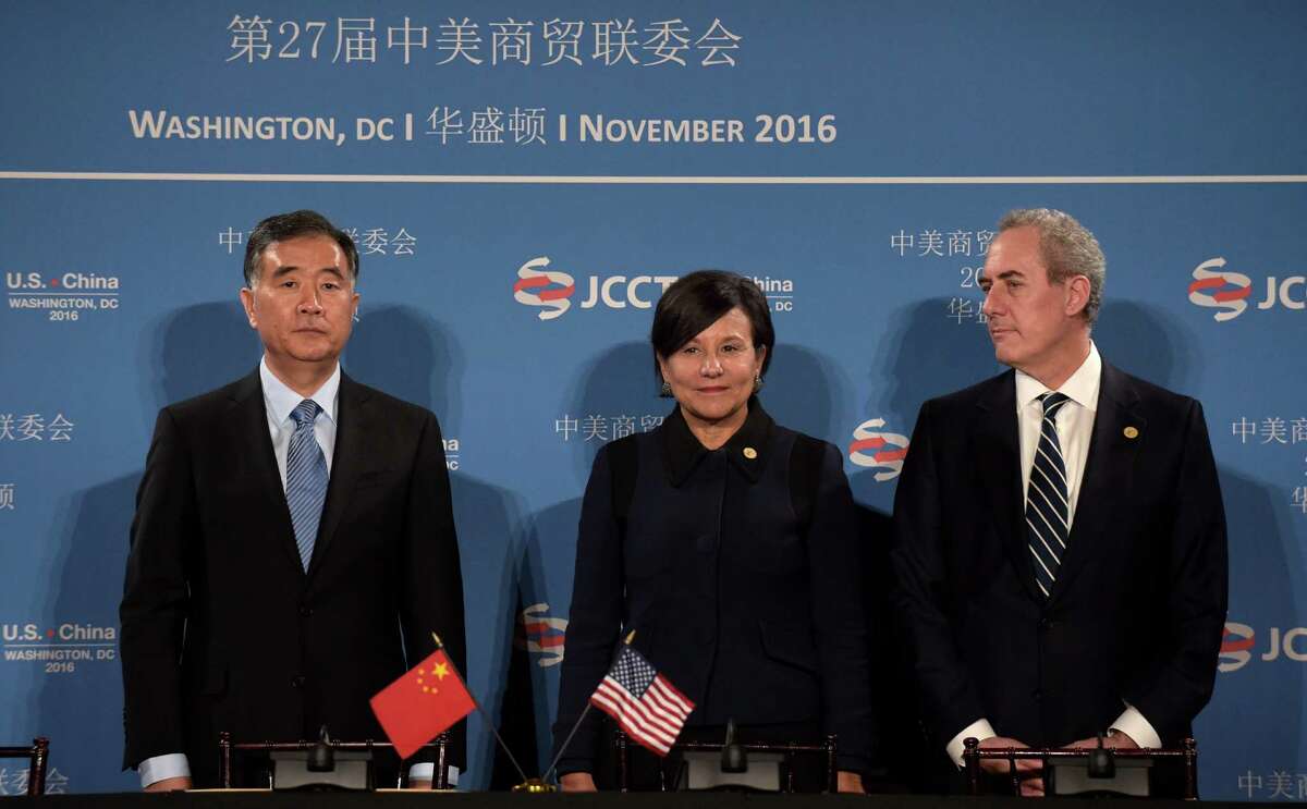 Commerce Secretary Penny Pritzker, center, stands with Chinese Vice Premier of the State Council Wang Yang, left, and U.S. Trade Representative Ambassador Michael Froman, before the start of a signing ceremony at the 27th session of the U.S.-China Joint Commission on Commerce and Trade in Washington, Wednesday, Nov. 23, 2016. (AP Photo/Susan Walsh)