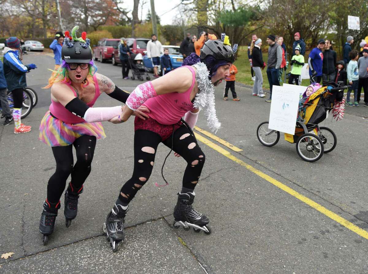 Jim McCaffrey, left, of Trumbull, and Jeff Piedmont, of Stamford, rollerblade in costume before the start of the Shippan Turkey Trot at Shippan Point in Stamford, Conn. Thursday, Nov. 24, 2016. The Thankgiving Day fun run, now in its 16th year, drew about 300 participants dressed in a variety of wacky and holiday-themed costumes. An estimated $10,000 raised by the run goes 100% to meal programs at Stamford's Pacific House.