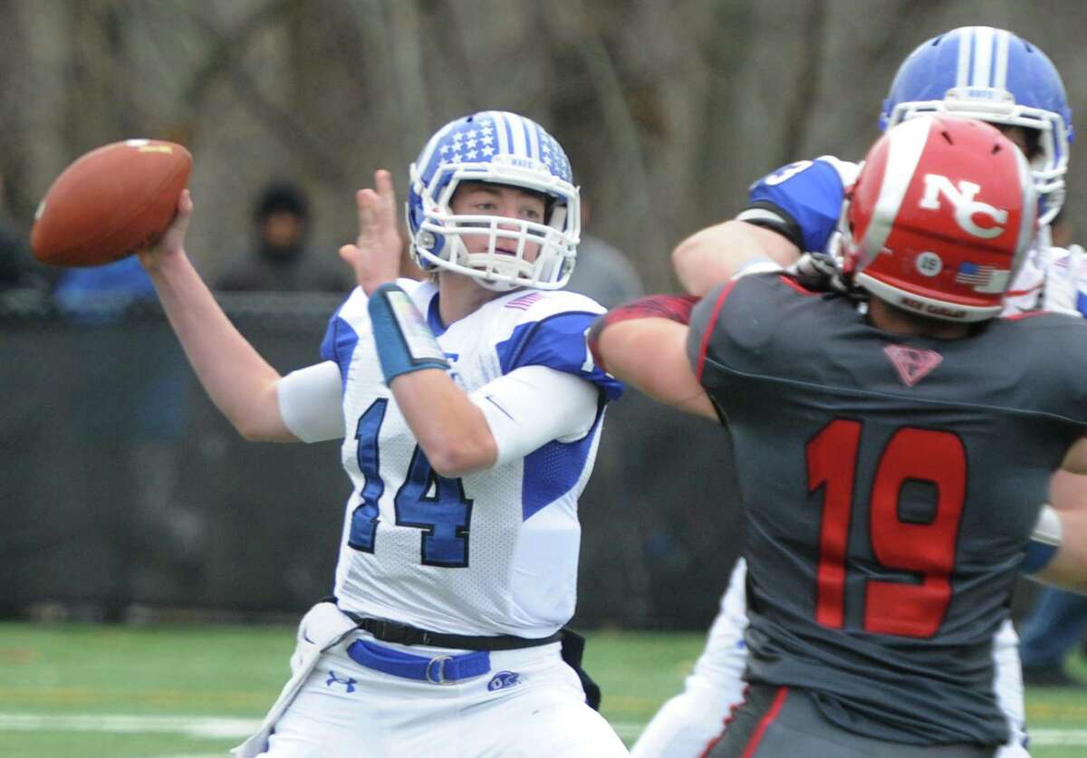 Darien quarterback Brian Peters throws a pass in Darien's 37-34 win over New Canaan in the Turkey Bowl high school football game at Dunning Stadium in New Canaan, Conn. Thursday, Nov. 24, 2016. New Canaan scored 24 unanswered points to tie the game and force an overtime. In overtime, Darien kicked a field goal to take the lead and forced a New Canaan interception to end the game, setting off a wild celebration as fans stormed the field.