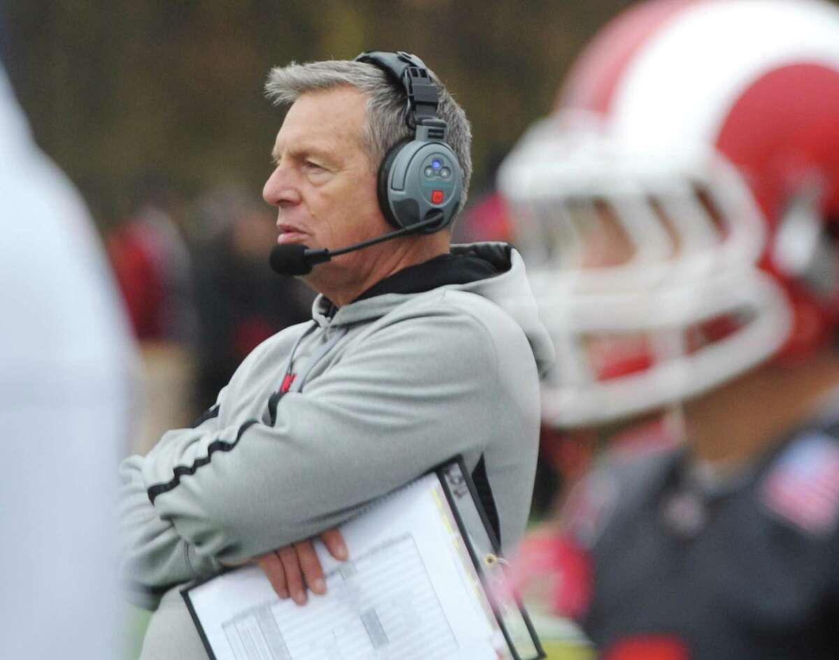 New Canaan head coach Lou Marinelli watches on the sidelines during Darien's 37-34 win over New Canaan in the Turkey Bowl high school football game at Dunning Stadium in New Canaan, Conn. Thursday, Nov. 24, 2016. New Canaan scored 24 unanswered points to tie the game and force an overtime. In overtime, Darien kicked a field goal to take the lead and forced a New Canaan interception to end the game, setting off a wild celebration as fans stormed the field.