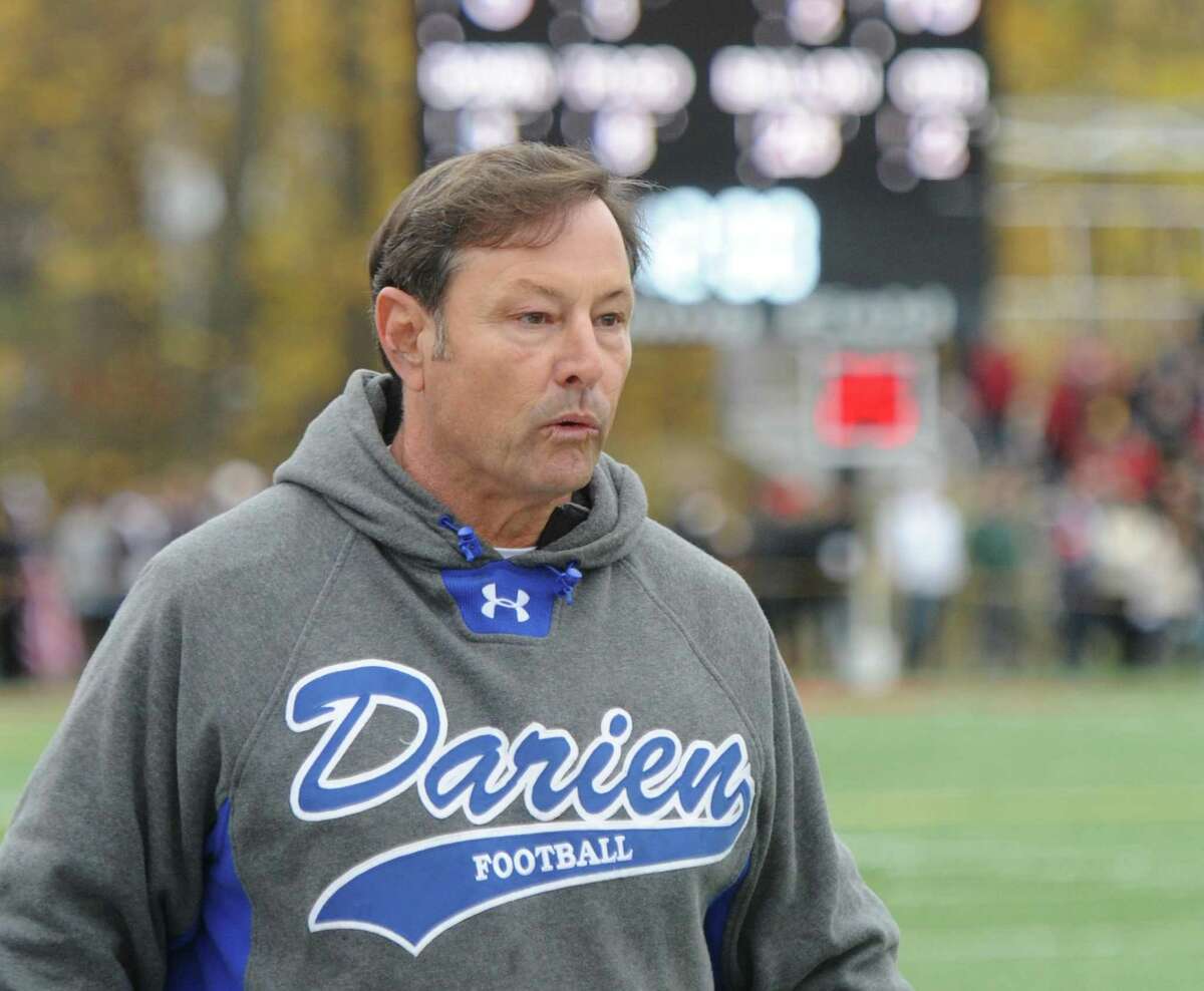 Photos from Darien's 37-34 win over New Canaan in the Turkey Bowl high school football game at Dunning Stadium in New Canaan, Conn. Thursday, Nov. 24, 2016. New Canaan scored 24 unanswered points to tie the game and force an overtime. In overtime, Darien kicked a field goal to take the lead and forced a New Canaan interception to end the game, setting off a wild celebration as fans stormed the field.
