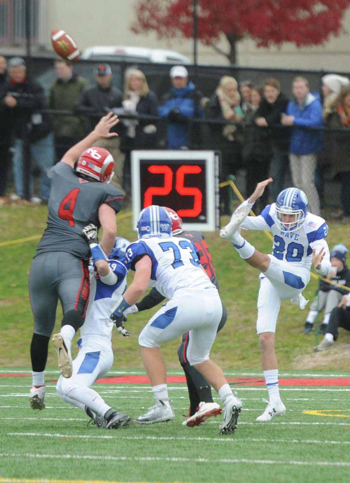 Photos from Darien's 37-34 win over New Canaan in the Turkey Bowl high school football game at Dunning Stadium in New Canaan, Conn. Thursday, Nov. 24, 2016. New Canaan scored 24 unanswered points to tie the game and force an overtime. In overtime, Darien kicked a field goal to take the lead and forced a New Canaan interception to end the game, setting off a wild celebration as fans stormed the field.