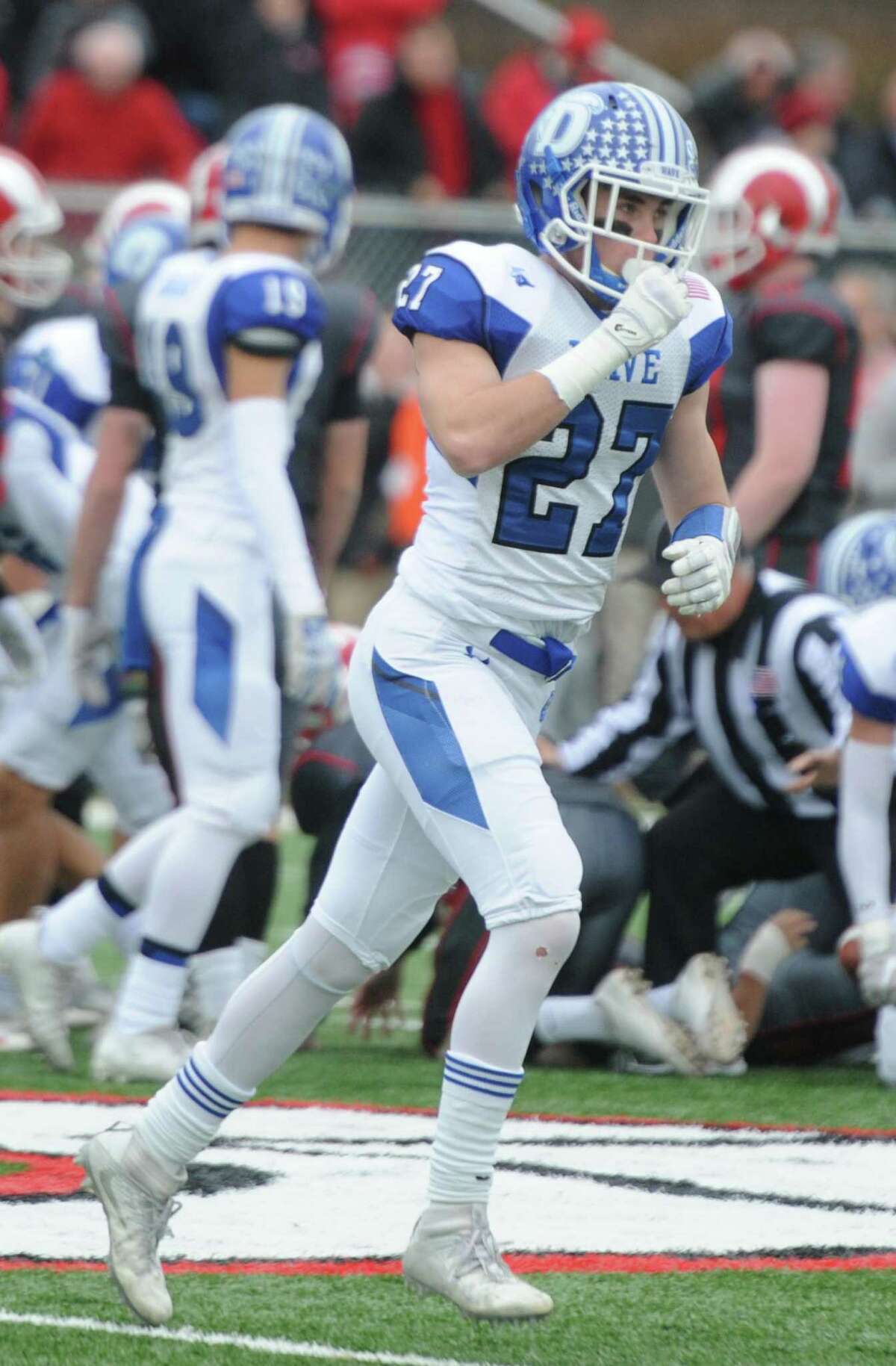 Photos from Darien's 37-34 win over New Canaan in the Turkey Bowl high school football game at Dunning Stadium in New Canaan, Conn. Thursday, Nov. 24, 2016. New Canaan scored 24 unanswered points to tie the game and force an overtime. In overtime, Darien kicked a field goal to take the lead and forced a New Canaan interception to end the game, setting off a wild celebration as fans stormed the field.