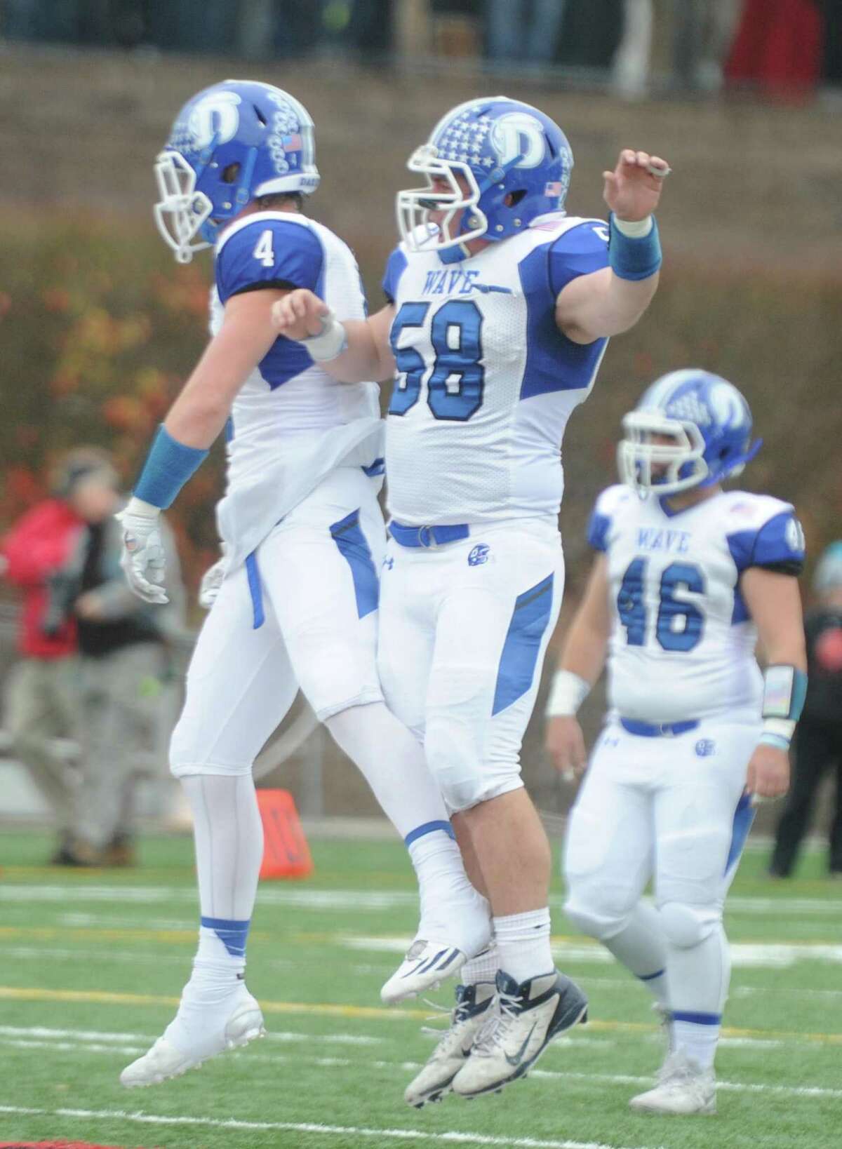 Photos from Darien's 37-34 win over New Canaan in the Turkey Bowl high school football game at Dunning Stadium in New Canaan, Conn. Thursday, Nov. 24, 2016. New Canaan scored 24 unanswered points to tie the game and force an overtime. In overtime, Darien kicked a field goal to take the lead and forced a New Canaan interception to end the game, setting off a wild celebration as fans stormed the field.