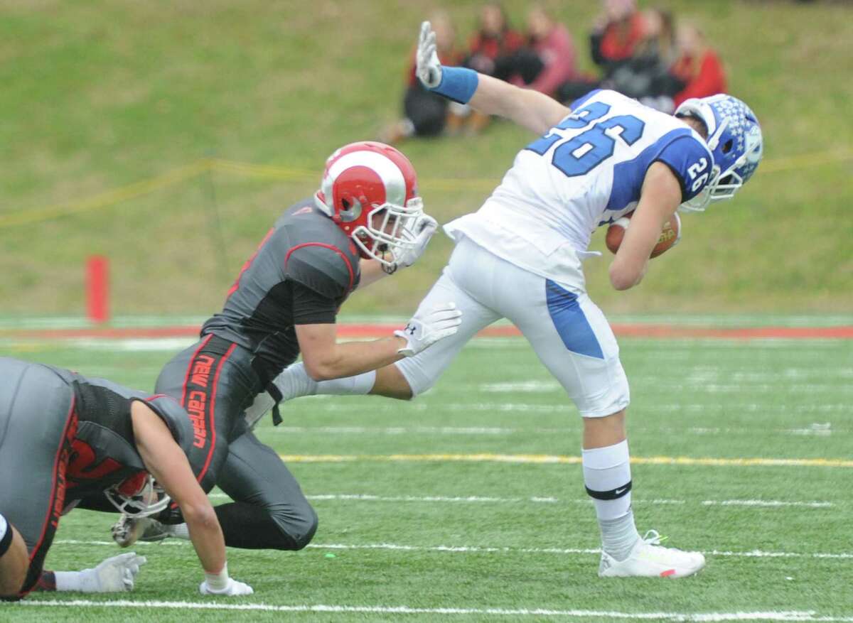 Photos from Darien's 37-34 win over New Canaan in the Turkey Bowl high school football game at Dunning Stadium in New Canaan, Conn. Thursday, Nov. 24, 2016. New Canaan scored 24 unanswered points to tie the game and force an overtime. In overtime, Darien kicked a field goal to take the lead and forced a New Canaan interception to end the game, setting off a wild celebration as fans stormed the field.