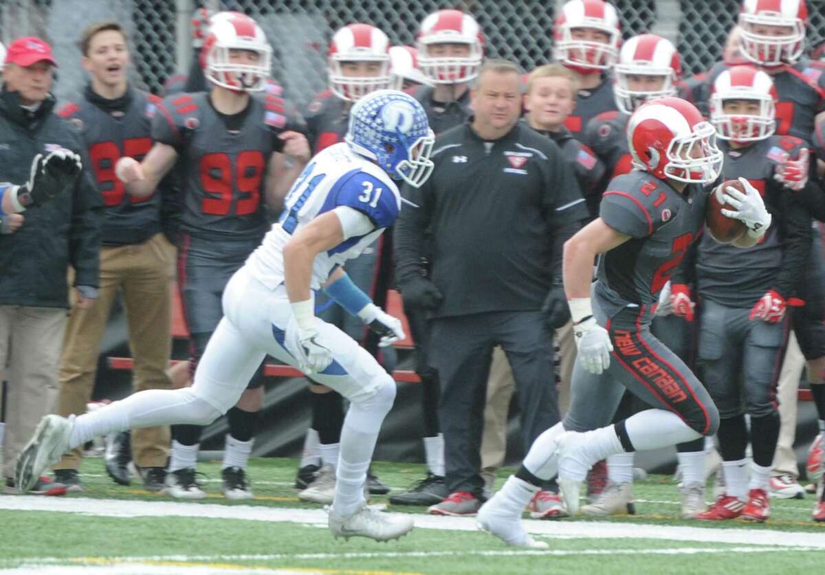 Photos from Darien's 37-34 win over New Canaan in the Turkey Bowl high school football game at Dunning Stadium in New Canaan, Conn. Thursday, Nov. 24, 2016. New Canaan scored 24 unanswered points to tie the game and force an overtime. In overtime, Darien kicked a field goal to take the lead and forced a New Canaan interception to end the game, setting off a wild celebration as fans stormed the field.