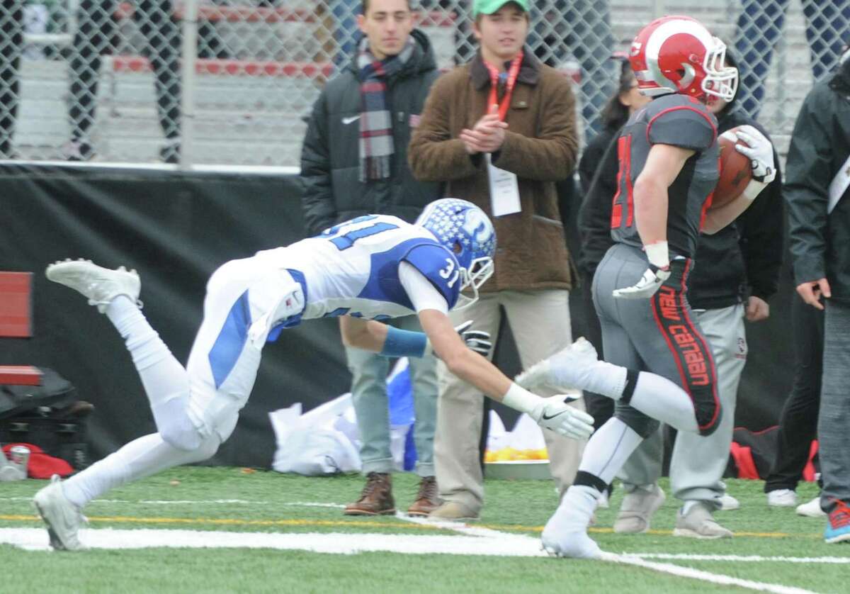 Photos from Darien's 37-34 win over New Canaan in the Turkey Bowl high school football game at Dunning Stadium in New Canaan, Conn. Thursday, Nov. 24, 2016. New Canaan scored 24 unanswered points to tie the game and force an overtime. In overtime, Darien kicked a field goal to take the lead and forced a New Canaan interception to end the game, setting off a wild celebration as fans stormed the field.