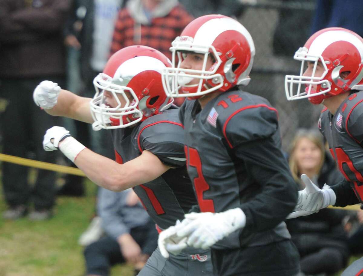 Photos from Darien's 37-34 win over New Canaan in the Turkey Bowl high school football game at Dunning Stadium in New Canaan, Conn. Thursday, Nov. 24, 2016. New Canaan scored 24 unanswered points to tie the game and force an overtime. In overtime, Darien kicked a field goal to take the lead and forced a New Canaan interception to end the game, setting off a wild celebration as fans stormed the field.