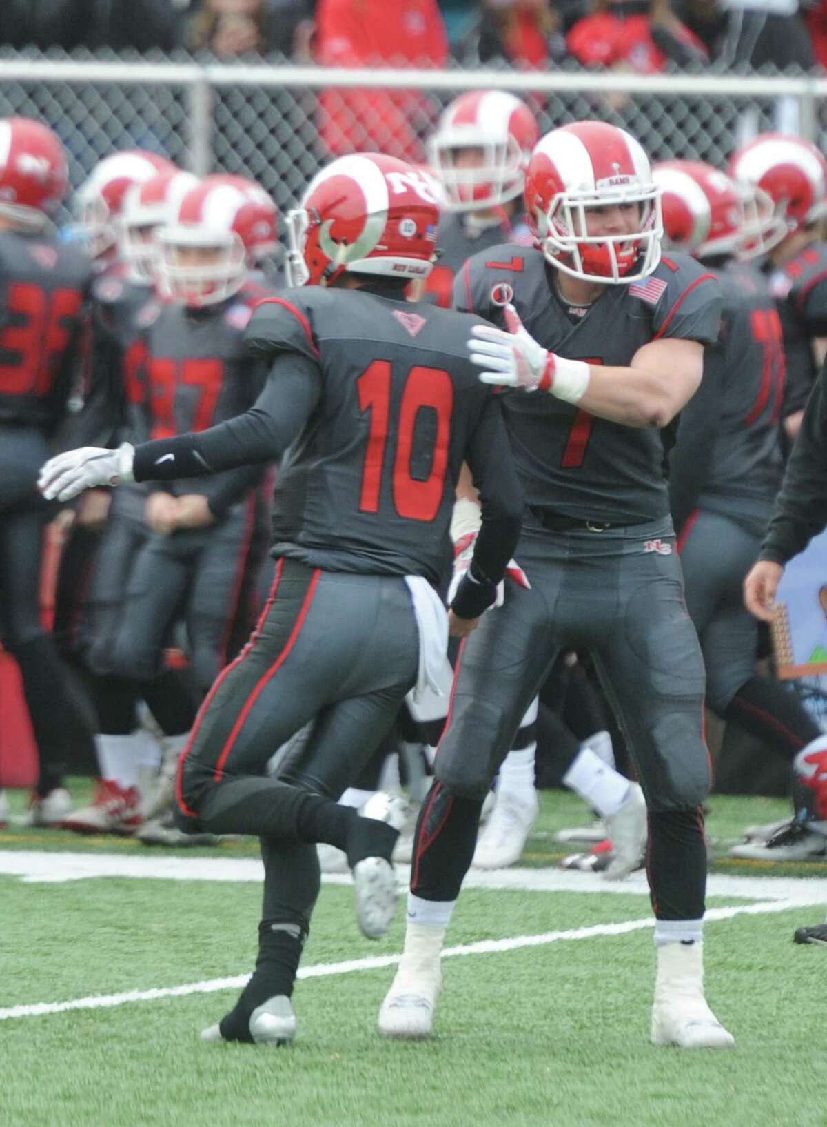 Photos from Darien's 37-34 win over New Canaan in the Turkey Bowl high school football game at Dunning Stadium in New Canaan, Conn. Thursday, Nov. 24, 2016. New Canaan scored 24 unanswered points to tie the game and force an overtime. In overtime, Darien kicked a field goal to take the lead and forced a New Canaan interception to end the game, setting off a wild celebration as fans stormed the field.
