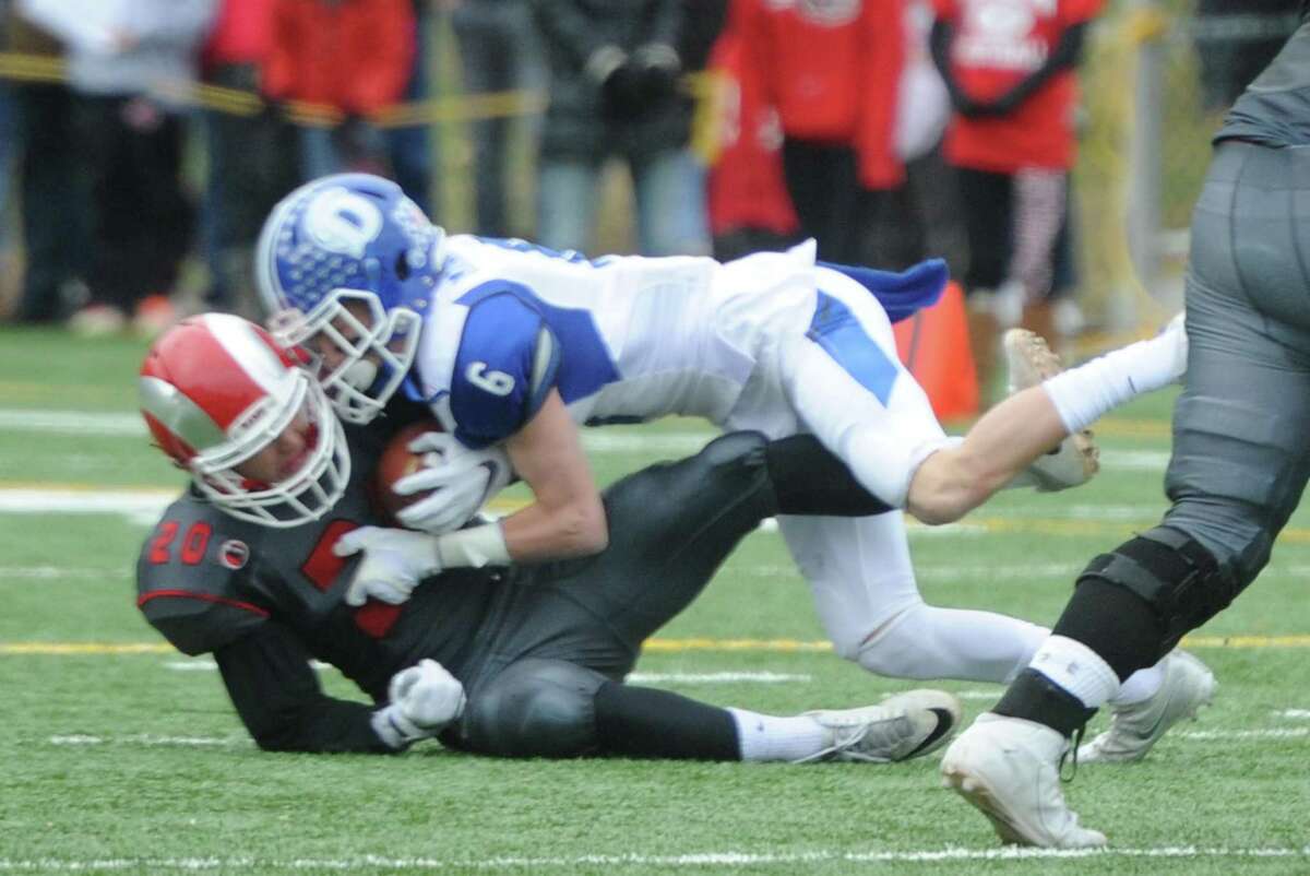 Photos from Darien's 37-34 win over New Canaan in the Turkey Bowl high school football game at Dunning Stadium in New Canaan, Conn. Thursday, Nov. 24, 2016. New Canaan scored 24 unanswered points to tie the game and force an overtime. In overtime, Darien kicked a field goal to take the lead and forced a New Canaan interception to end the game, setting off a wild celebration as fans stormed the field.