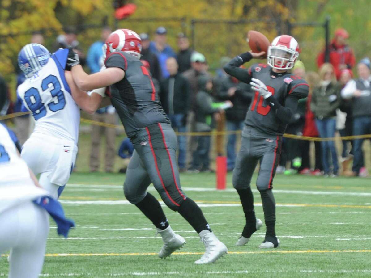 Photos from Darien's 37-34 win over New Canaan in the Turkey Bowl high school football game at Dunning Stadium in New Canaan, Conn. Thursday, Nov. 24, 2016. New Canaan scored 24 unanswered points to tie the game and force an overtime. In overtime, Darien kicked a field goal to take the lead and forced a New Canaan interception to end the game, setting off a wild celebration as fans stormed the field.