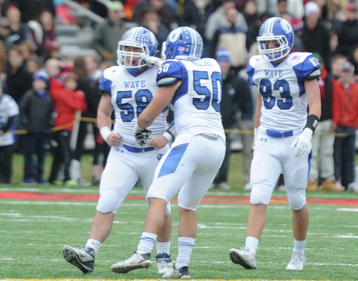Photos from Darien's 37-34 win over New Canaan in the Turkey Bowl high school football game at Dunning Stadium in New Canaan, Conn. Thursday, Nov. 24, 2016. New Canaan scored 24 unanswered points to tie the game and force an overtime. In overtime, Darien kicked a field goal to take the lead and forced a New Canaan interception to end the game, setting off a wild celebration as fans stormed the field.