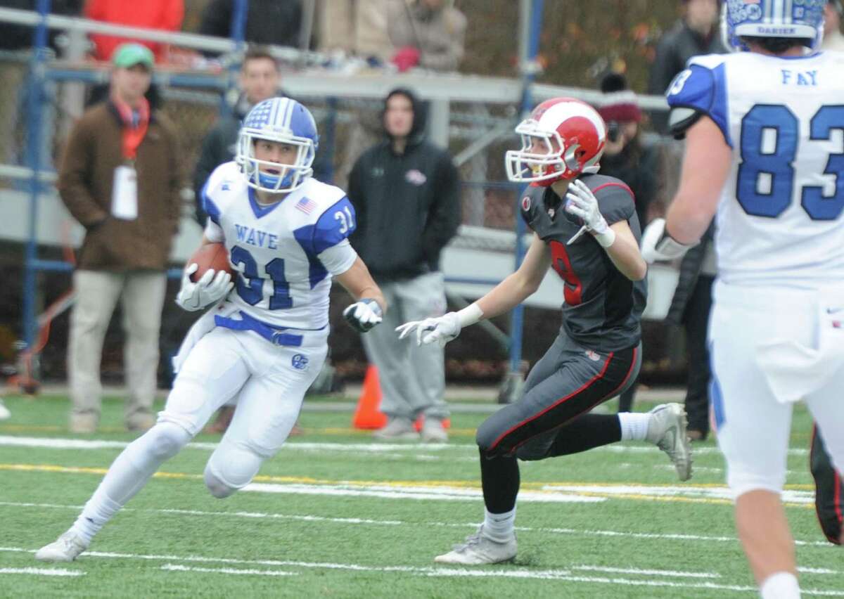 Photos from Darien's 37-34 win over New Canaan in the Turkey Bowl high school football game at Dunning Stadium in New Canaan, Conn. Thursday, Nov. 24, 2016. New Canaan scored 24 unanswered points to tie the game and force an overtime. In overtime, Darien kicked a field goal to take the lead and forced a New Canaan interception to end the game, setting off a wild celebration as fans stormed the field.