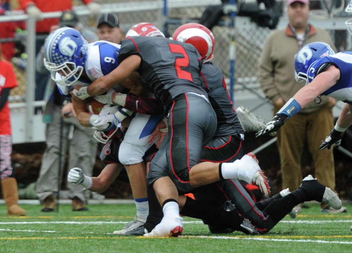 Photos from Darien's 37-34 win over New Canaan in the Turkey Bowl high school football game at Dunning Stadium in New Canaan, Conn. Thursday, Nov. 24, 2016. New Canaan scored 24 unanswered points to tie the game and force an overtime. In overtime, Darien kicked a field goal to take the lead and forced a New Canaan interception to end the game, setting off a wild celebration as fans stormed the field.