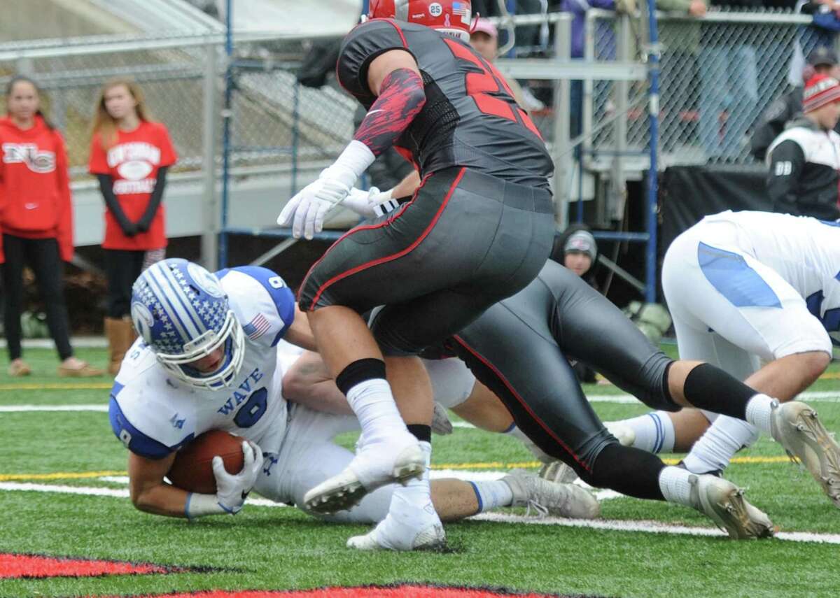 Photos from Darien's 37-34 win over New Canaan in the Turkey Bowl high school football game at Dunning Stadium in New Canaan, Conn. Thursday, Nov. 24, 2016. New Canaan scored 24 unanswered points to tie the game and force an overtime. In overtime, Darien kicked a field goal to take the lead and forced a New Canaan interception to end the game, setting off a wild celebration as fans stormed the field.