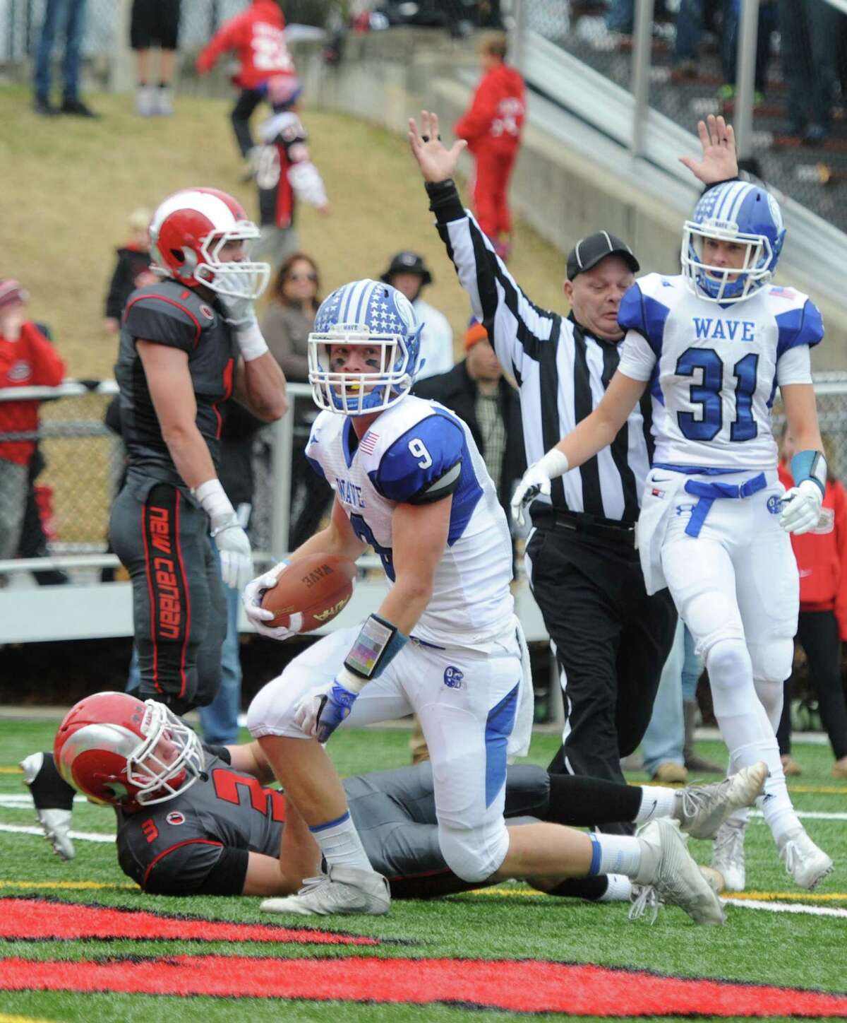 Photos from Darien's 37-34 win over New Canaan in the Turkey Bowl high school football game at Dunning Stadium in New Canaan, Conn. Thursday, Nov. 24, 2016. New Canaan scored 24 unanswered points to tie the game and force an overtime. In overtime, Darien kicked a field goal to take the lead and forced a New Canaan interception to end the game, setting off a wild celebration as fans stormed the field.