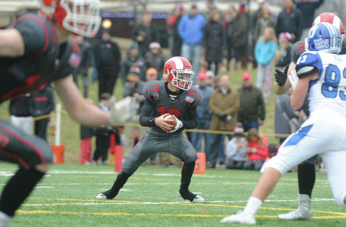 Photos from Darien's 37-34 win over New Canaan in the Turkey Bowl high school football game at Dunning Stadium in New Canaan, Conn. Thursday, Nov. 24, 2016. New Canaan scored 24 unanswered points to tie the game and force an overtime. In overtime, Darien kicked a field goal to take the lead and forced a New Canaan interception to end the game, setting off a wild celebration as fans stormed the field.
