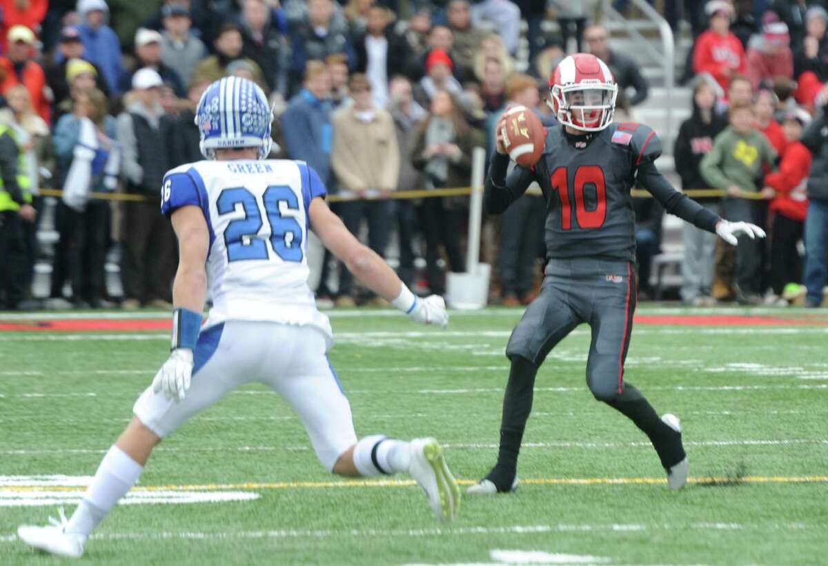Photos from Darien's 37-34 win over New Canaan in the Turkey Bowl high school football game at Dunning Stadium in New Canaan, Conn. Thursday, Nov. 24, 2016. New Canaan scored 24 unanswered points to tie the game and force an overtime. In overtime, Darien kicked a field goal to take the lead and forced a New Canaan interception to end the game, setting off a wild celebration as fans stormed the field.