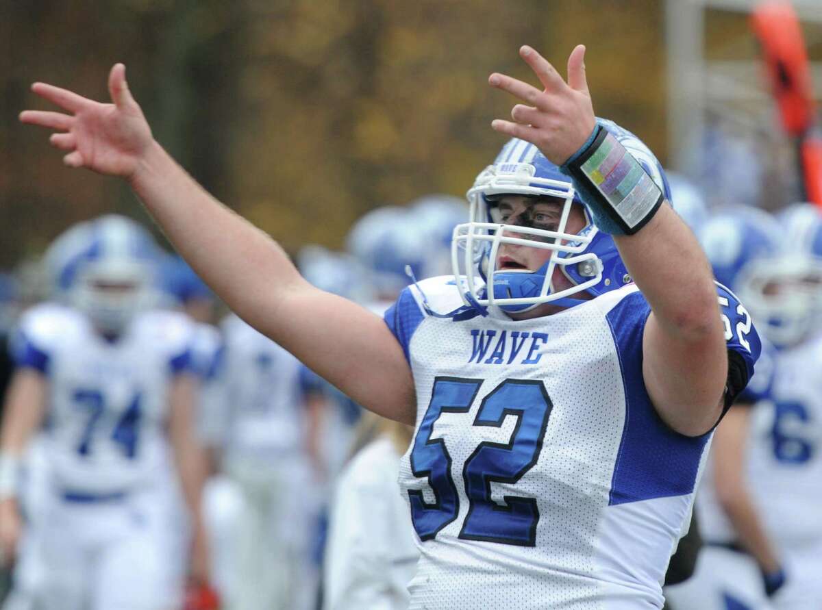 Photos from Darien's 37-34 win over New Canaan in the Turkey Bowl high school football game at Dunning Stadium in New Canaan, Conn. Thursday, Nov. 24, 2016. New Canaan scored 24 unanswered points to tie the game and force an overtime. In overtime, Darien kicked a field goal to take the lead and forced a New Canaan interception to end the game, setting off a wild celebration as fans stormed the field.