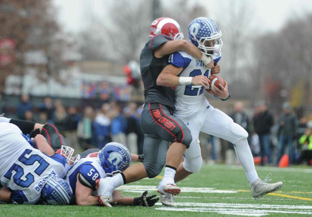 Photos from Darien's 37-34 win over New Canaan in the Turkey Bowl high school football game at Dunning Stadium in New Canaan, Conn. Thursday, Nov. 24, 2016. New Canaan scored 24 unanswered points to tie the game and force an overtime. In overtime, Darien kicked a field goal to take the lead and forced a New Canaan interception to end the game, setting off a wild celebration as fans stormed the field.
