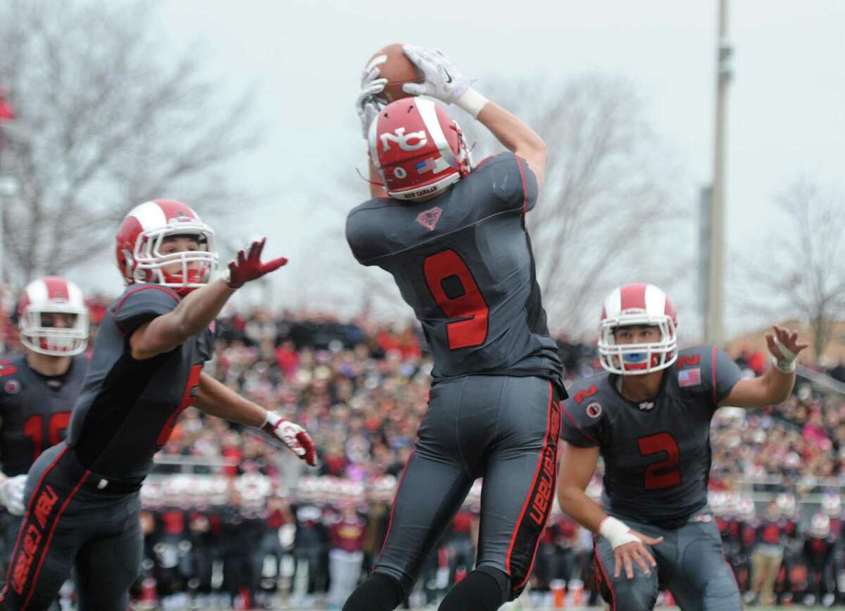Photos from Darien's 37-34 win over New Canaan in the Turkey Bowl high school football game at Dunning Stadium in New Canaan, Conn. Thursday, Nov. 24, 2016. New Canaan scored 24 unanswered points to tie the game and force an overtime. In overtime, Darien kicked a field goal to take the lead and forced a New Canaan interception to end the game, setting off a wild celebration as fans stormed the field.