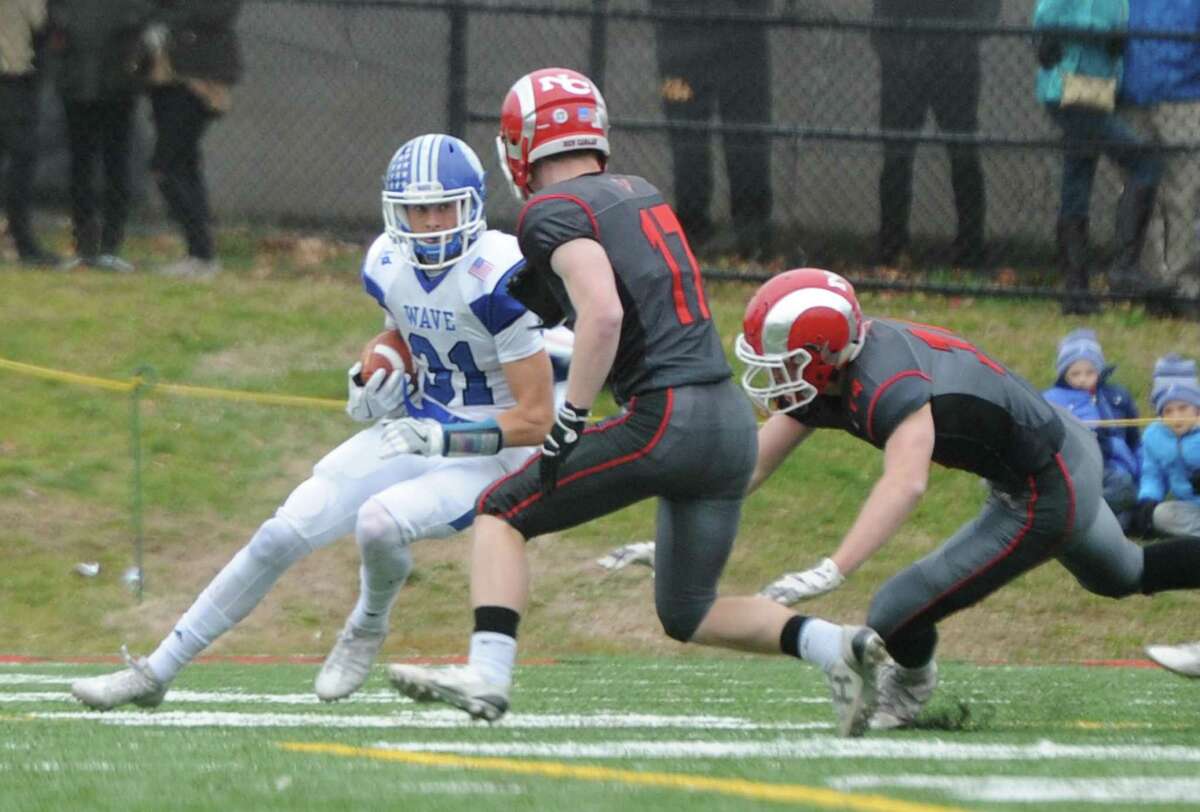 Photos from Darien's 37-34 win over New Canaan in the Turkey Bowl high school football game at Dunning Stadium in New Canaan, Conn. Thursday, Nov. 24, 2016. New Canaan scored 24 unanswered points to tie the game and force an overtime. In overtime, Darien kicked a field goal to take the lead and forced a New Canaan interception to end the game, setting off a wild celebration as fans stormed the field.