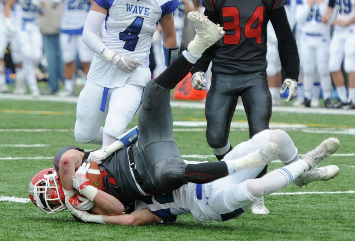 Photos from Darien's 37-34 win over New Canaan in the Turkey Bowl high school football game at Dunning Stadium in New Canaan, Conn. Thursday, Nov. 24, 2016. New Canaan scored 24 unanswered points to tie the game and force an overtime. In overtime, Darien kicked a field goal to take the lead and forced a New Canaan interception to end the game, setting off a wild celebration as fans stormed the field.