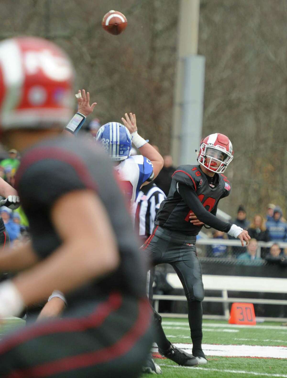 Photos from Darien's 37-34 win over New Canaan in the Turkey Bowl high school football game at Dunning Stadium in New Canaan, Conn. Thursday, Nov. 24, 2016. New Canaan scored 24 unanswered points to tie the game and force an overtime. In overtime, Darien kicked a field goal to take the lead and forced a New Canaan interception to end the game, setting off a wild celebration as fans stormed the field.