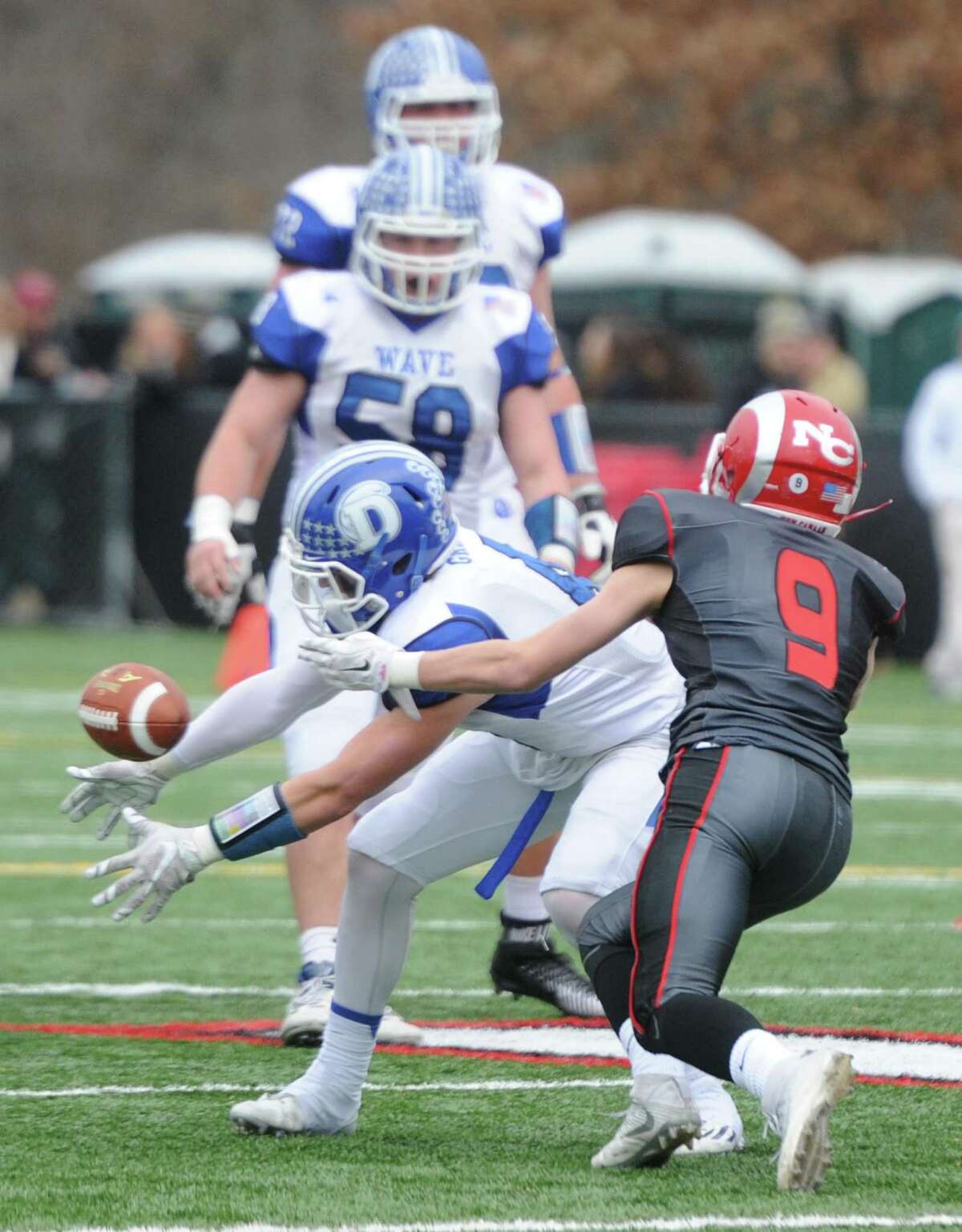 Photos from Darien's 37-34 win over New Canaan in the Turkey Bowl high school football game at Dunning Stadium in New Canaan, Conn. Thursday, Nov. 24, 2016. New Canaan scored 24 unanswered points to tie the game and force an overtime. In overtime, Darien kicked a field goal to take the lead and forced a New Canaan interception to end the game, setting off a wild celebration as fans stormed the field.