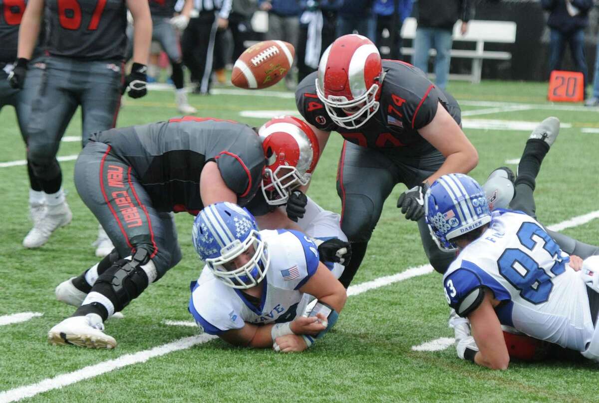 Photos from Darien's 37-34 win over New Canaan in the Turkey Bowl high school football game at Dunning Stadium in New Canaan, Conn. Thursday, Nov. 24, 2016. New Canaan scored 24 unanswered points to tie the game and force an overtime. In overtime, Darien kicked a field goal to take the lead and forced a New Canaan interception to end the game, setting off a wild celebration as fans stormed the field.