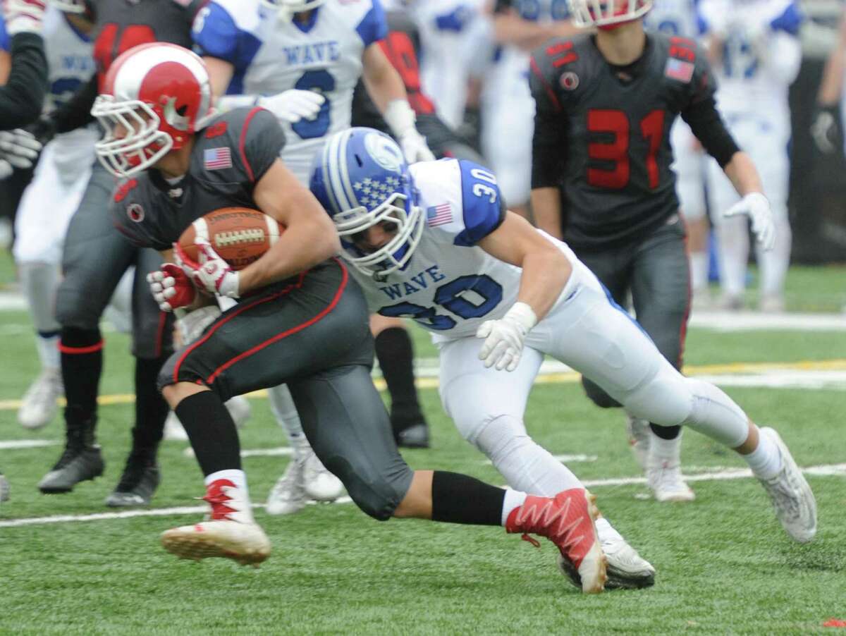 Photos from Darien's 37-34 win over New Canaan in the Turkey Bowl high school football game at Dunning Stadium in New Canaan, Conn. Thursday, Nov. 24, 2016. New Canaan scored 24 unanswered points to tie the game and force an overtime. In overtime, Darien kicked a field goal to take the lead and forced a New Canaan interception to end the game, setting off a wild celebration as fans stormed the field.