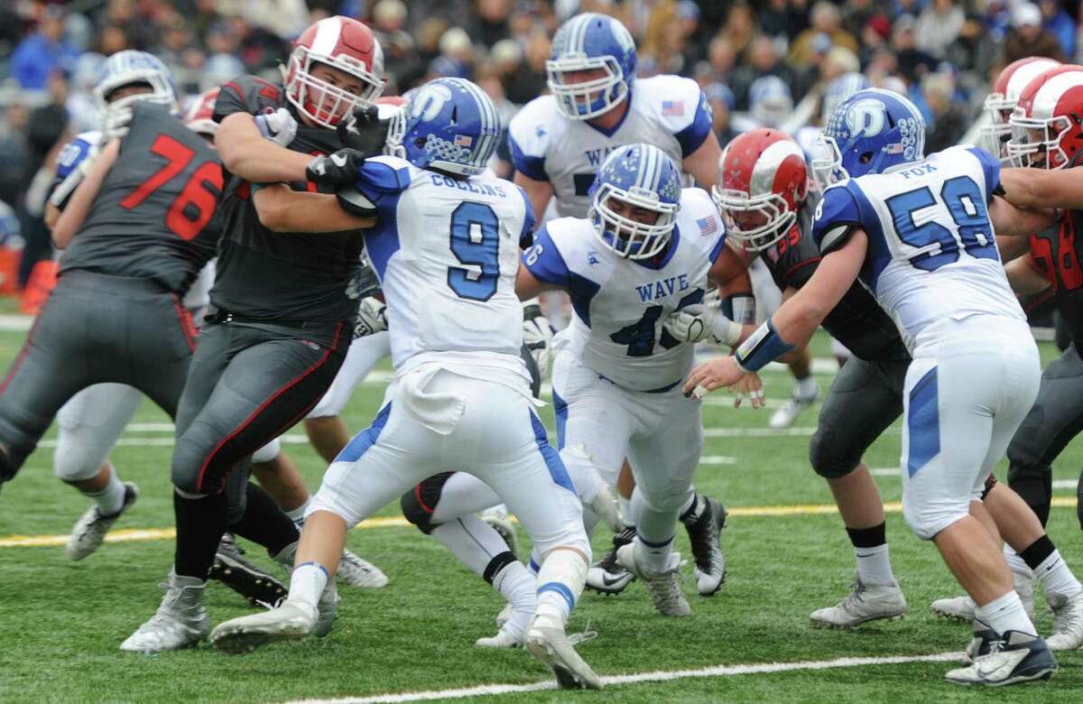 Photos from Darien's 37-34 win over New Canaan in the Turkey Bowl high school football game at Dunning Stadium in New Canaan, Conn. Thursday, Nov. 24, 2016. New Canaan scored 24 unanswered points to tie the game and force an overtime. In overtime, Darien kicked a field goal to take the lead and forced a New Canaan interception to end the game, setting off a wild celebration as fans stormed the field.