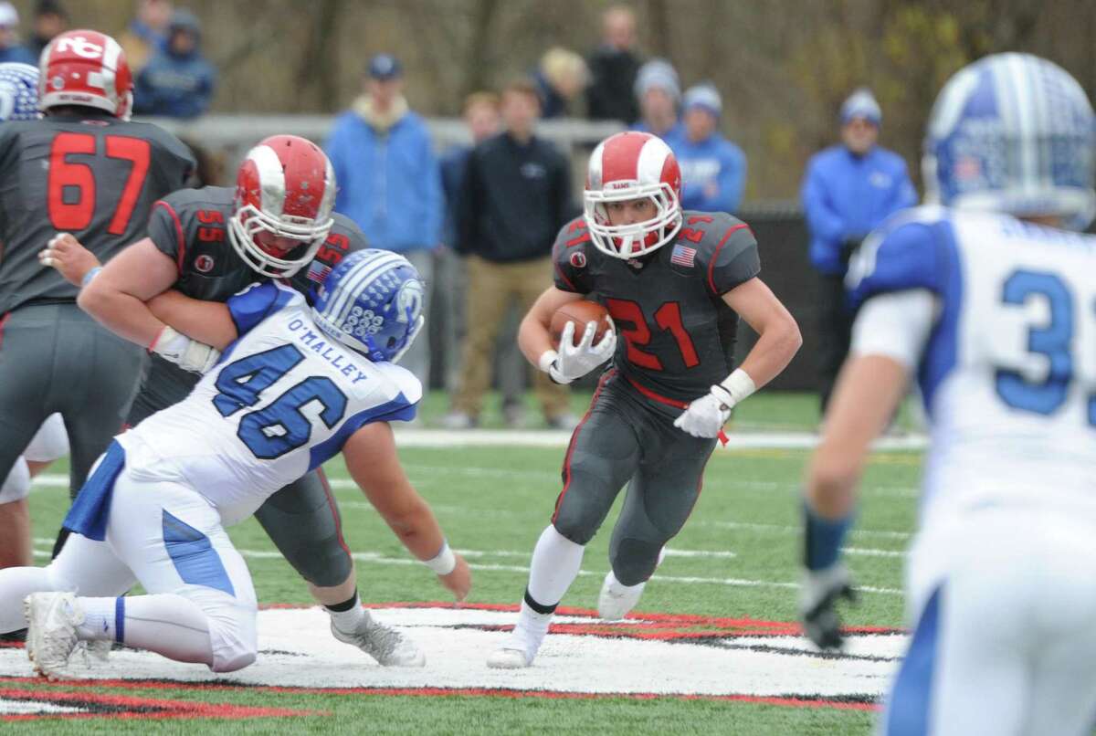 Photos from Darien's 37-34 win over New Canaan in the Turkey Bowl high school football game at Dunning Stadium in New Canaan, Conn. Thursday, Nov. 24, 2016. New Canaan scored 24 unanswered points to tie the game and force an overtime. In overtime, Darien kicked a field goal to take the lead and forced a New Canaan interception to end the game, setting off a wild celebration as fans stormed the field.