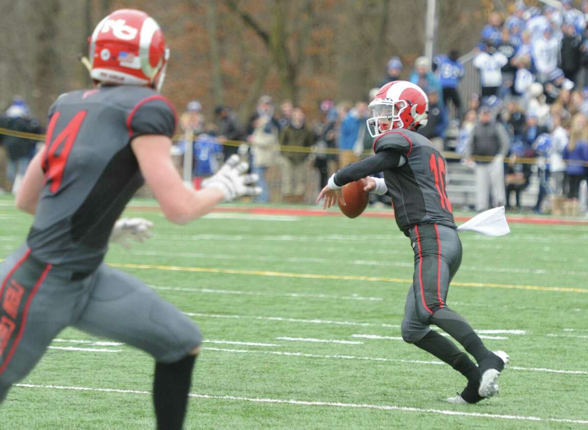 Photos from Darien's 37-34 win over New Canaan in the Turkey Bowl high school football game at Dunning Stadium in New Canaan, Conn. Thursday, Nov. 24, 2016. New Canaan scored 24 unanswered points to tie the game and force an overtime. In overtime, Darien kicked a field goal to take the lead and forced a New Canaan interception to end the game, setting off a wild celebration as fans stormed the field.