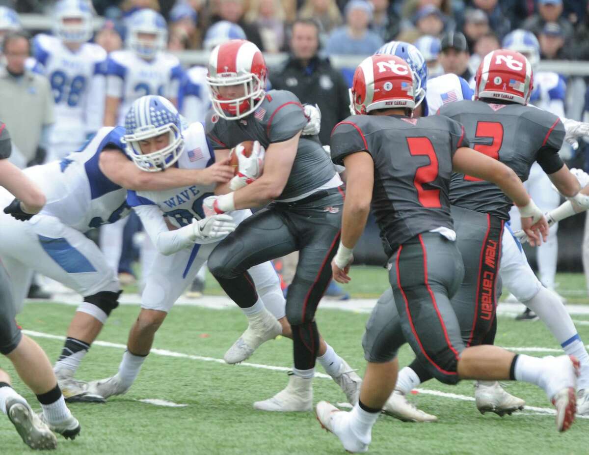 Photos from Darien's 37-34 win over New Canaan in the Turkey Bowl high school football game at Dunning Stadium in New Canaan, Conn. Thursday, Nov. 24, 2016. New Canaan scored 24 unanswered points to tie the game and force an overtime. In overtime, Darien kicked a field goal to take the lead and forced a New Canaan interception to end the game, setting off a wild celebration as fans stormed the field.