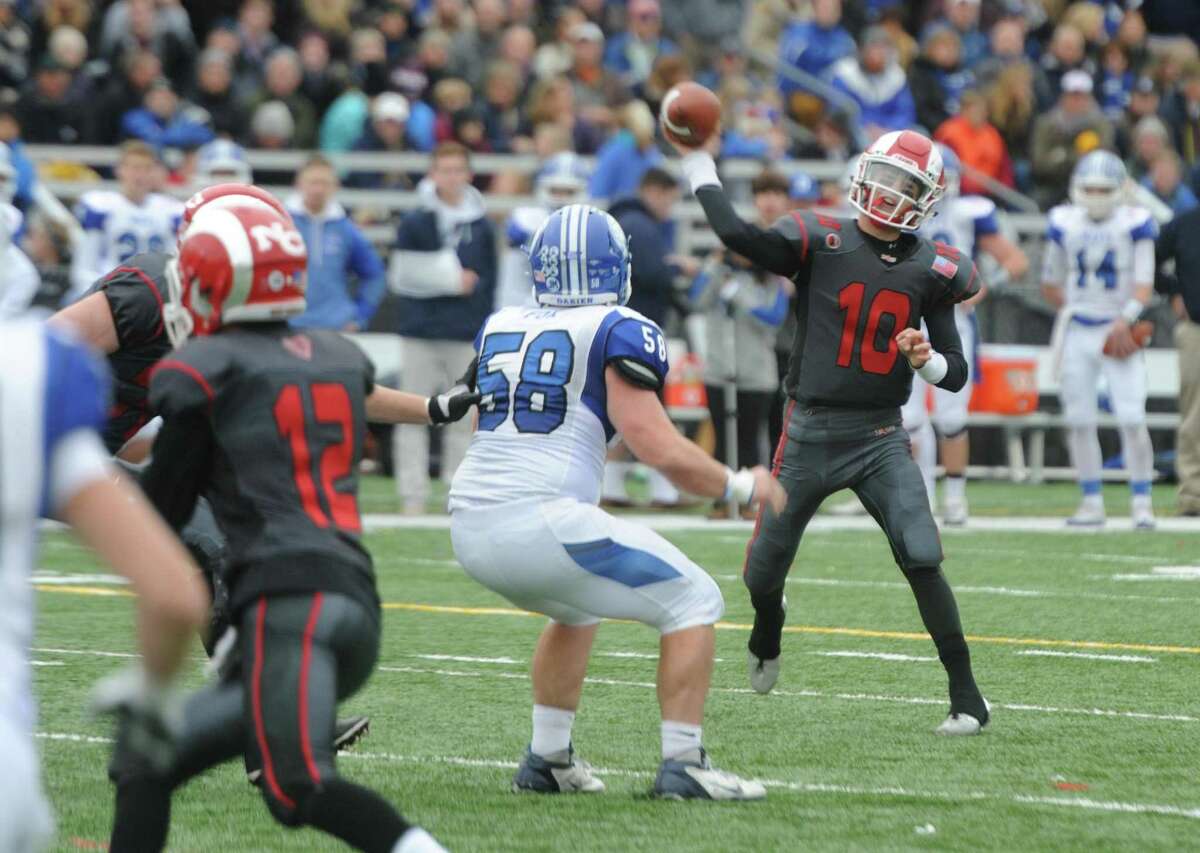 Photos from Darien's 37-34 win over New Canaan in the Turkey Bowl high school football game at Dunning Stadium in New Canaan, Conn. Thursday, Nov. 24, 2016. New Canaan scored 24 unanswered points to tie the game and force an overtime. In overtime, Darien kicked a field goal to take the lead and forced a New Canaan interception to end the game, setting off a wild celebration as fans stormed the field.