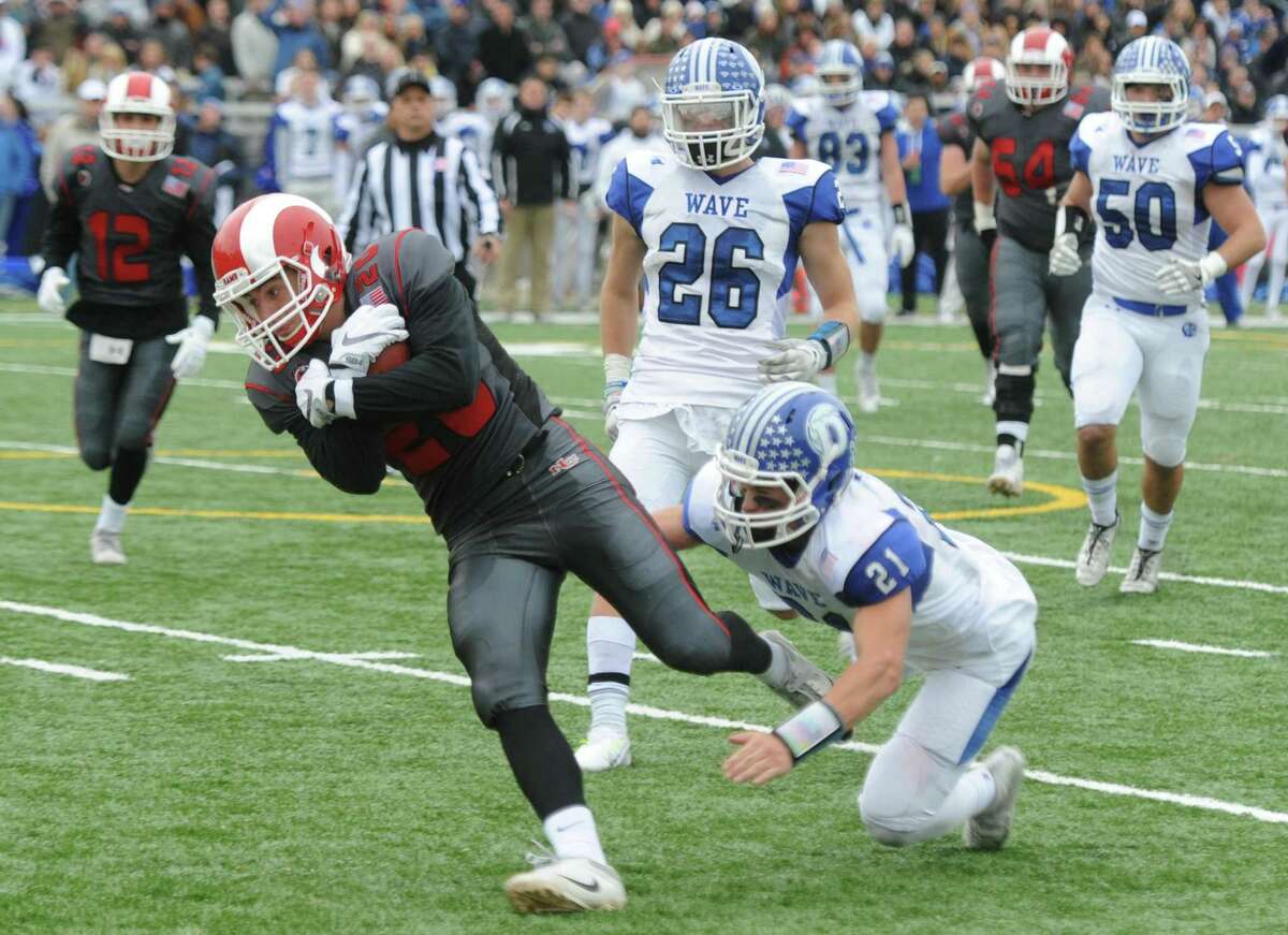 Photos from Darien's 37-34 win over New Canaan in the Turkey Bowl high school football game at Dunning Stadium in New Canaan, Conn. Thursday, Nov. 24, 2016. New Canaan scored 24 unanswered points to tie the game and force an overtime. In overtime, Darien kicked a field goal to take the lead and forced a New Canaan interception to end the game, setting off a wild celebration as fans stormed the field.