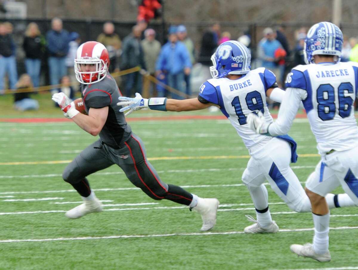 Photos from Darien's 37-34 win over New Canaan in the Turkey Bowl high school football game at Dunning Stadium in New Canaan, Conn. Thursday, Nov. 24, 2016. New Canaan scored 24 unanswered points to tie the game and force an overtime. In overtime, Darien kicked a field goal to take the lead and forced a New Canaan interception to end the game, setting off a wild celebration as fans stormed the field.
