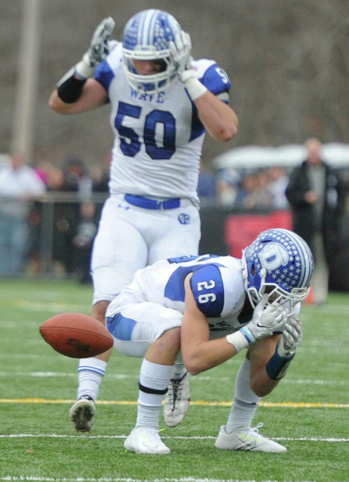 Photos from Darien's 37-34 win over New Canaan in the Turkey Bowl high school football game at Dunning Stadium in New Canaan, Conn. Thursday, Nov. 24, 2016. New Canaan scored 24 unanswered points to tie the game and force an overtime. In overtime, Darien kicked a field goal to take the lead and forced a New Canaan interception to end the game, setting off a wild celebration as fans stormed the field.