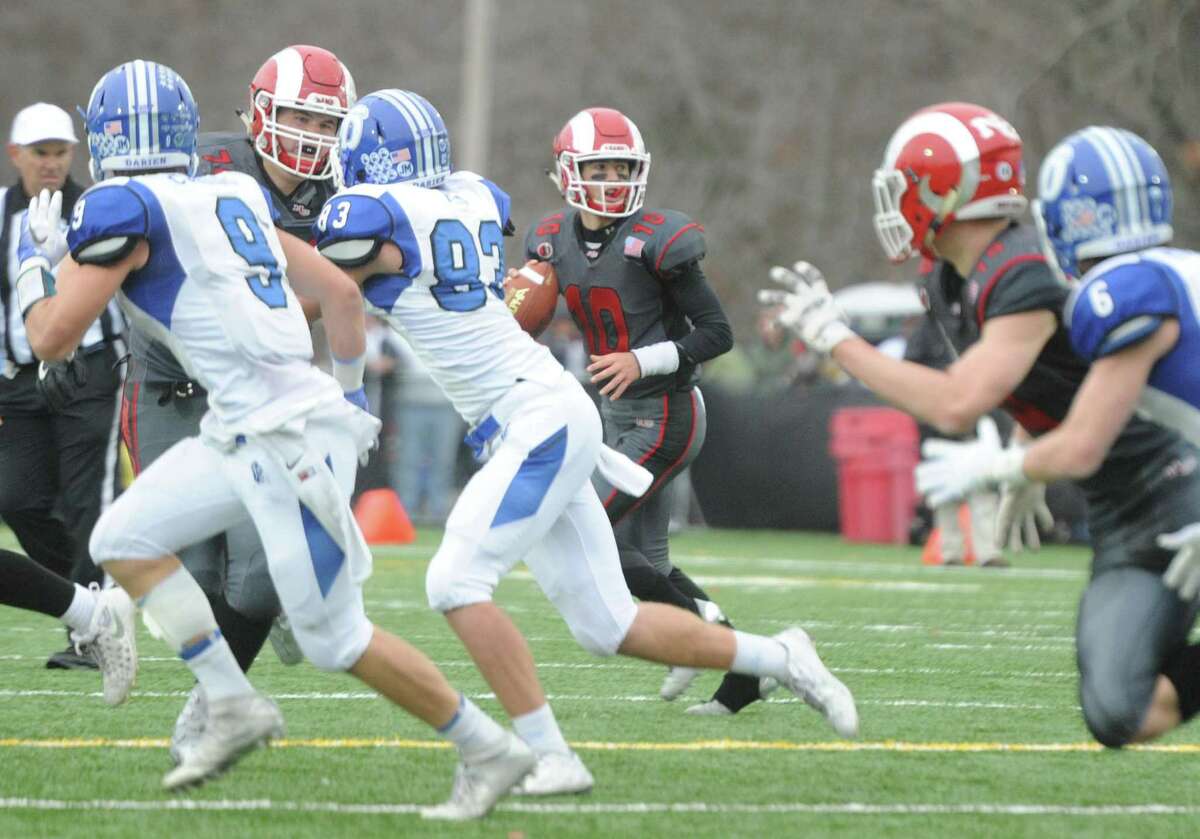 Photos from Darien's 37-34 win over New Canaan in the Turkey Bowl high school football game at Dunning Stadium in New Canaan, Conn. Thursday, Nov. 24, 2016. New Canaan scored 24 unanswered points to tie the game and force an overtime. In overtime, Darien kicked a field goal to take the lead and forced a New Canaan interception to end the game, setting off a wild celebration as fans stormed the field.
